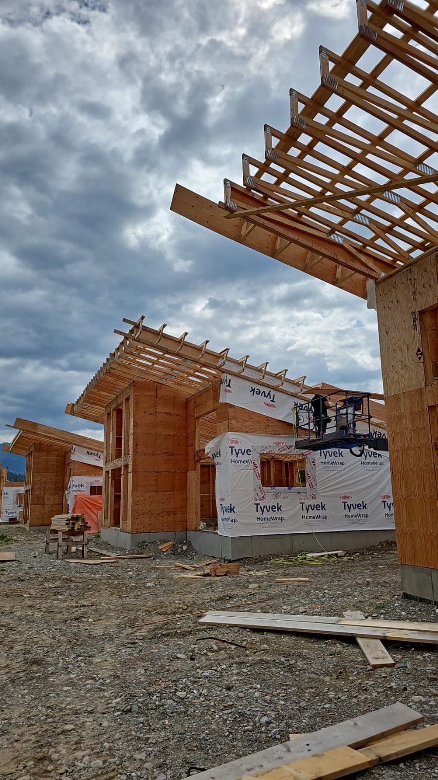 Timber-framed cabins with shed roofs under construction