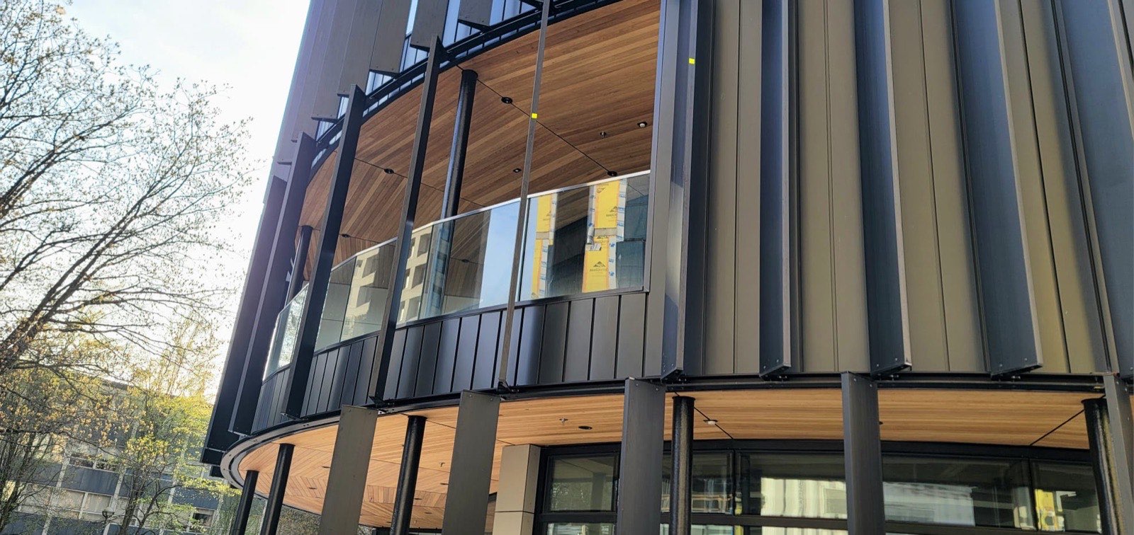 Curved clear cedar soffit on the upper floor of the building